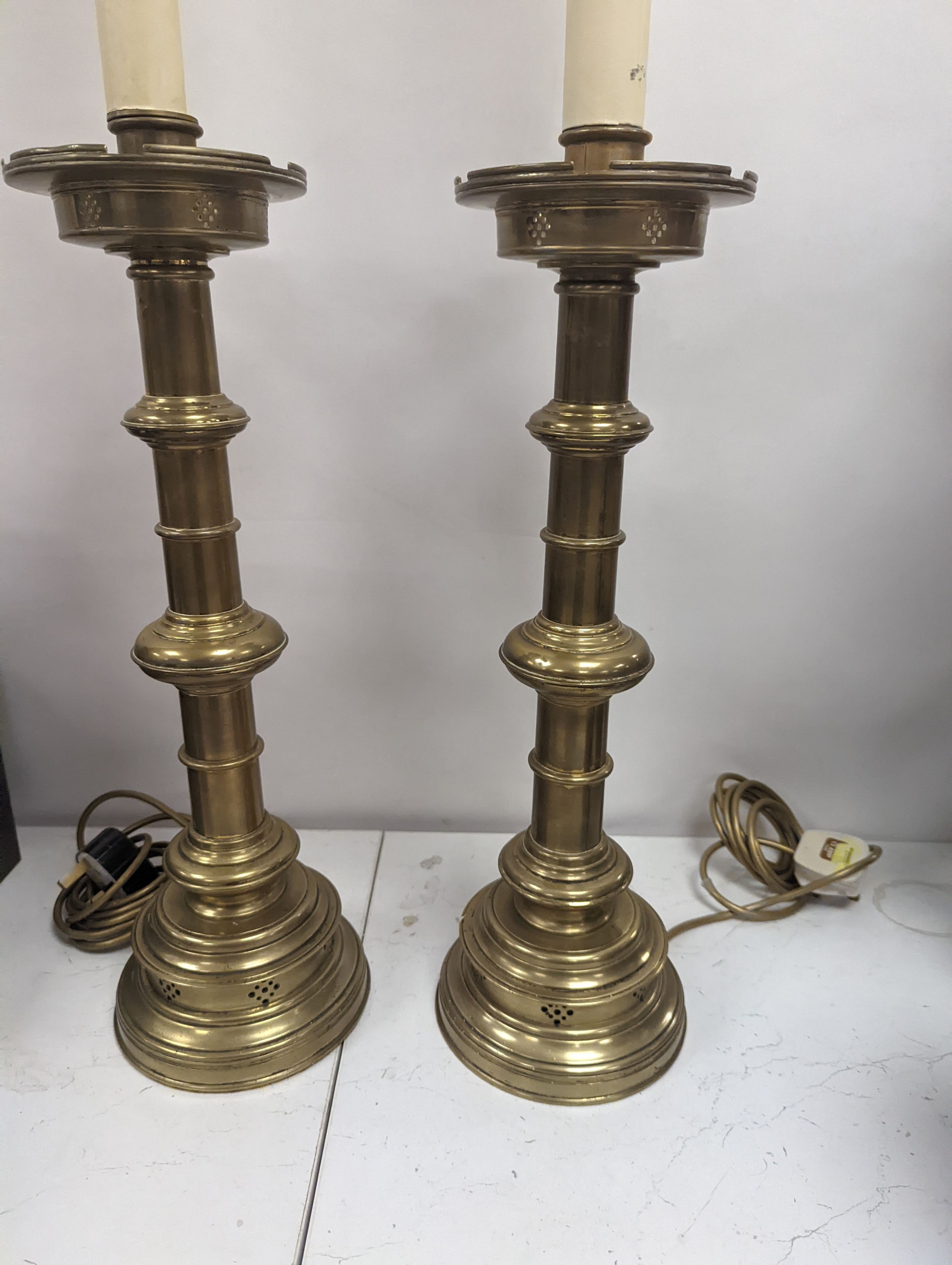 A pair of Gothic style brass table lamps, height 79cm